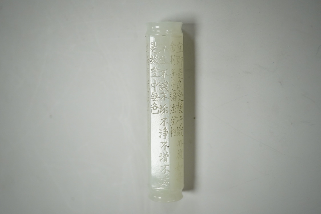 A Chinese pale celadon jade inscribed cylinder bead, 6.5cm long